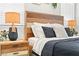 Well-lit bedroom showcasing a wooden headboard, decorative pillows, and a modern bedside lamp at 7350 N Decatur Blvd # 5, Las Vegas, NV 89131