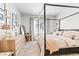 Bright bedroom features a four-poster bed, dresser, stylish mirror, and charming bedside decor at 7350 N Decatur Blvd # 5, Las Vegas, NV 89131
