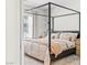 Bedroom featuring a four-poster bed, soft bedding, and plenty of natural light at 7350 N Decatur Blvd # 5, Las Vegas, NV 89131