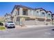 Newer two-story townhome featuring attached garages and neutral paint scheme and decorative stone accents at 7350 N Decatur Blvd # 5, Las Vegas, NV 89131