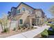 Exterior view of a new two-story home with a well-manicured yard, showcasing a modern design at 7350 N Decatur Blvd # 5, Las Vegas, NV 89131
