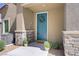Close-up of a front door featuring stone accents, manicured shrubs, and a welcoming wreath at 7350 N Decatur Blvd # 5, Las Vegas, NV 89131