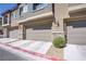 Attached garages with stone accents and driveways for easy access and parking at 7350 N Decatur Blvd # 5, Las Vegas, NV 89131