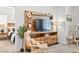 Bright living room with custom wooden entertainment center and inviting chair, open to bedroom at 7350 N Decatur Blvd # 5, Las Vegas, NV 89131