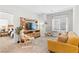Bright living room showcasing a comfortable yellow sofa, stylish chair, and entertainment center at 7350 N Decatur Blvd # 5, Las Vegas, NV 89131