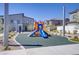 Community playground featuring a slide and climbing structures, surrounded by modern townhomes and landscaping at 7350 N Decatur Blvd # 5, Las Vegas, NV 89131