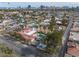 Aerial view shows the home with a pool, covered patio, desert landscape and cityscape view at 800 Kenny Way, Las Vegas, NV 89107