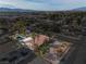 Aerial view showcases the single-story home, desert landscaping, terracotta roof, and mountain views at 800 Kenny Way, Las Vegas, NV 89107