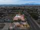 Aerial view showcases the single-story home, desert landscaping, terracotta roof, and mountain views at 800 Kenny Way, Las Vegas, NV 89107