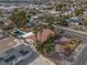 Aerial view showcases the single-story home with a pool, desert landscaping, and terracotta roof at 800 Kenny Way, Las Vegas, NV 89107