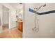 Updated bathroom featuring a tiled shower, a mirrored vanity, and oak cabinets at 800 Kenny Way, Las Vegas, NV 89107
