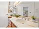 Bright bathroom vanity featuring oak cabinets, marble counters, an oval sink, and modern fixtures at 800 Kenny Way, Las Vegas, NV 89107