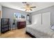Bedroom with wood floors, bright window, ceiling fan and decorative touches at 800 Kenny Way, Las Vegas, NV 89107