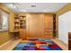 Cozy bedroom featuring custom built-ins, including a murphy bed and shelving, bathed in natural light at 800 Kenny Way, Las Vegas, NV 89107