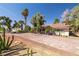 Charming single-story home featuring mature trees, desert landscaping and a brick paved driveway at 800 Kenny Way, Las Vegas, NV 89107