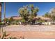 Expansive front yard of this single-story home, features mature trees, desert landscaping and a brick paved driveway at 800 Kenny Way, Las Vegas, NV 89107