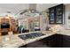 Well-appointed kitchen with a gas cooktop, granite countertops, and a seamless vent hood at 800 Kenny Way, Las Vegas, NV 89107