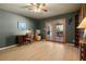 Inviting room with wood floors, ceiling fan, and french doors to the back patio at 800 Kenny Way, Las Vegas, NV 89107
