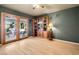 Inviting room with wood floors, custom bookcase and french doors to the back patio at 800 Kenny Way, Las Vegas, NV 89107