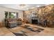 Comfortable living room featuring a stone fireplace, large windows, and cozy seating, creating a relaxing atmosphere at 800 Kenny Way, Las Vegas, NV 89107