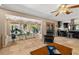 Open concept living room with tile floors, view of the backyard, and open to the kitchen at 800 Kenny Way, Las Vegas, NV 89107