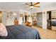 Spacious main bedroom featuring wood floors, a ceiling fan, and closet with mirrored doors at 800 Kenny Way, Las Vegas, NV 89107