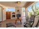 Covered patio with a built-in fireplace, seating area, and a desert-style garden, perfect for outdoor relaxing at 800 Kenny Way, Las Vegas, NV 89107