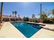 Backyard swimming pool surrounded by desert landscaping featuring a diving board and lounge area at 800 Kenny Way, Las Vegas, NV 89107