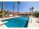 Backyard swimming pool with palm trees, diving board, and ample patio space for lounging and entertaining at 800 Kenny Way, Las Vegas, NV 89107