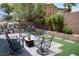 Picturesque backyard featuring stone wall, patio, faux grass, and a seating arrangement at 8122 Retriever Ave, Las Vegas, NV 89147