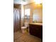 Bright bathroom featuring neutral-toned tile floors, granite countertops, and a single vanity at 8122 Retriever Ave, Las Vegas, NV 89147