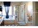 View of the bathroom featuring a bathtub, glass-enclosed shower, and a toilet at 8122 Retriever Ave, Las Vegas, NV 89147