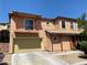 Charming two-story home featuring a balcony, covered entry, and a two-car garage with desert landscaping at 8122 Retriever Ave, Las Vegas, NV 89147