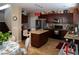 Well-appointed kitchen with dark wood cabinets, a center island, and stainless steel appliances in a cozy space at 8122 Retriever Ave, Las Vegas, NV 89147