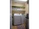 Functional laundry room with modern washer and dryer, plus shelving for ample storage at 8122 Retriever Ave, Las Vegas, NV 89147