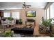 Inviting living space with tile floors, a fireplace with stone accent wall, and a ceiling fan for added comfort at 8122 Retriever Ave, Las Vegas, NV 89147