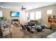 Spacious living room featuring tile flooring, a stone accent wall with fireplace, and an open floor plan at 8122 Retriever Ave, Las Vegas, NV 89147