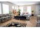 Bright living room with neutral walls, tile flooring, large windows, and stylish furniture throughout at 8122 Retriever Ave, Las Vegas, NV 89147
