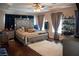 This main bedroom features a large bed, mirrored headboard, bedside tables, and lots of decorations at 8122 Retriever Ave, Las Vegas, NV 89147