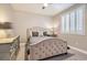 Cozy bedroom features a tufted headboard, neutral tones, and shuttered windows providing natural light at 8514 Garnet Lake Ave, Las Vegas, NV 89113