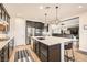 Open kitchen design with a large island, stainless appliances, and dark cabinets at 8514 Garnet Lake Ave, Las Vegas, NV 89113