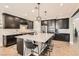 Elegant kitchen with a large central island, modern pendant lights, and stainless steel appliances at 8514 Garnet Lake Ave, Las Vegas, NV 89113