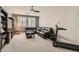 Cozy living room featuring a plush sectional, modern ceiling fan, and neutral carpeting at 8514 Garnet Lake Ave, Las Vegas, NV 89113