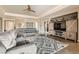 Comfortable living room features a ceiling fan, stylish entertainment center, and modern furniture at 8514 Garnet Lake Ave, Las Vegas, NV 89113