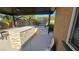 Covered outdoor kitchen features stone accents, a built-in grill, and ample counter space at 8514 Garnet Lake Ave, Las Vegas, NV 89113