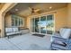Covered patio area offers comfortable seating and access to a backyard pool and outdoor lounge area at 8514 Garnet Lake Ave, Las Vegas, NV 89113