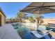 Resort-style backyard pool with in-pool loungers, spa, and desert landscaping create a serene oasis at 8514 Garnet Lake Ave, Las Vegas, NV 89113