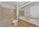Comfortable bathroom with tub and shower, updated hardware, and a sink with wood cabinetry at 9013 Litchfield Ave, Las Vegas, NV 89134