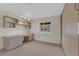 Well-lit bedroom with custom built-ins, large desk, and a view of the neighborhood at 9013 Litchfield Ave, Las Vegas, NV 89134