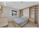 Comfortable bedroom featuring custom shelving and peaceful natural light at 9013 Litchfield Ave, Las Vegas, NV 89134